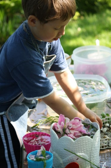 preschooler playing with water and flowers
