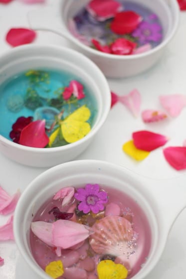kids making fairy soup with water and flowers