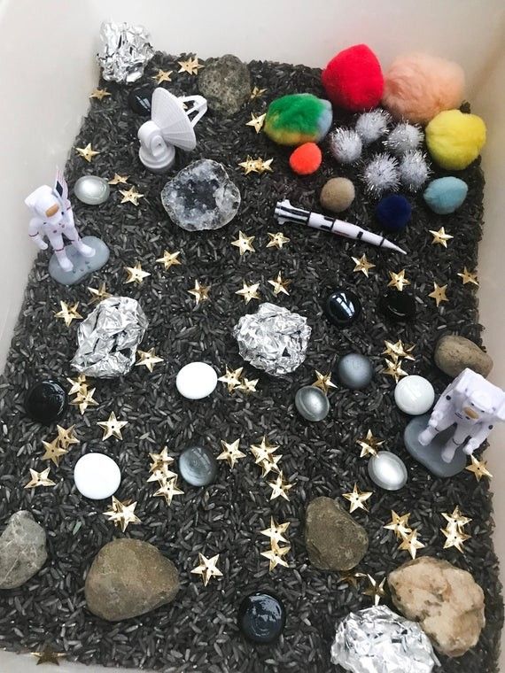 This may contain: there are many rocks and other items on the floor