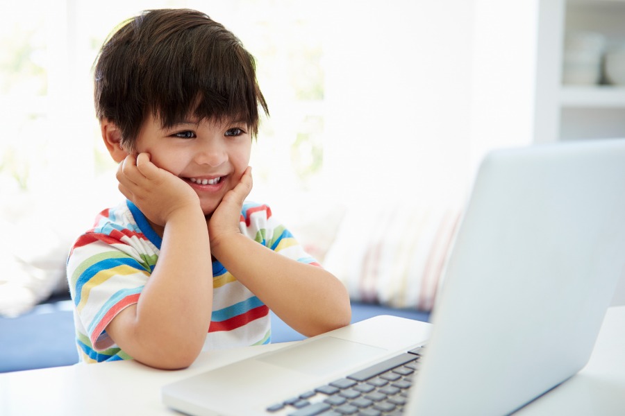 This is a photo of a child on a computer doing virtual learning. 