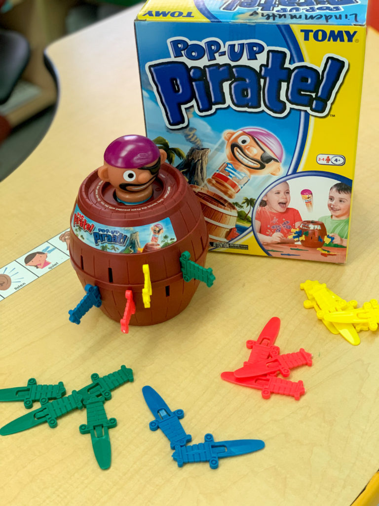 This is a photo of the game Pop Up Pirate.  There is a barrel, pirate, and colored swords that are placed in the barrel. 