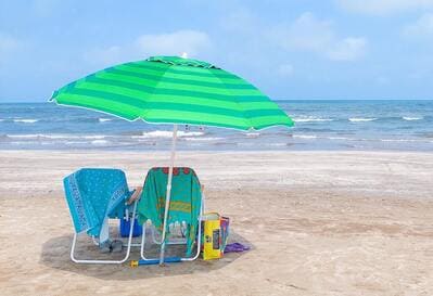 set of beach chairs and umbrella on the beach