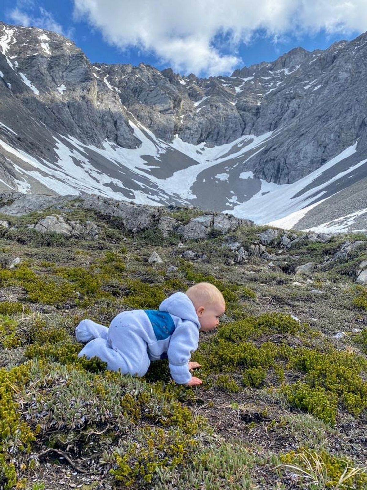 baby crawling in beautiful mountains