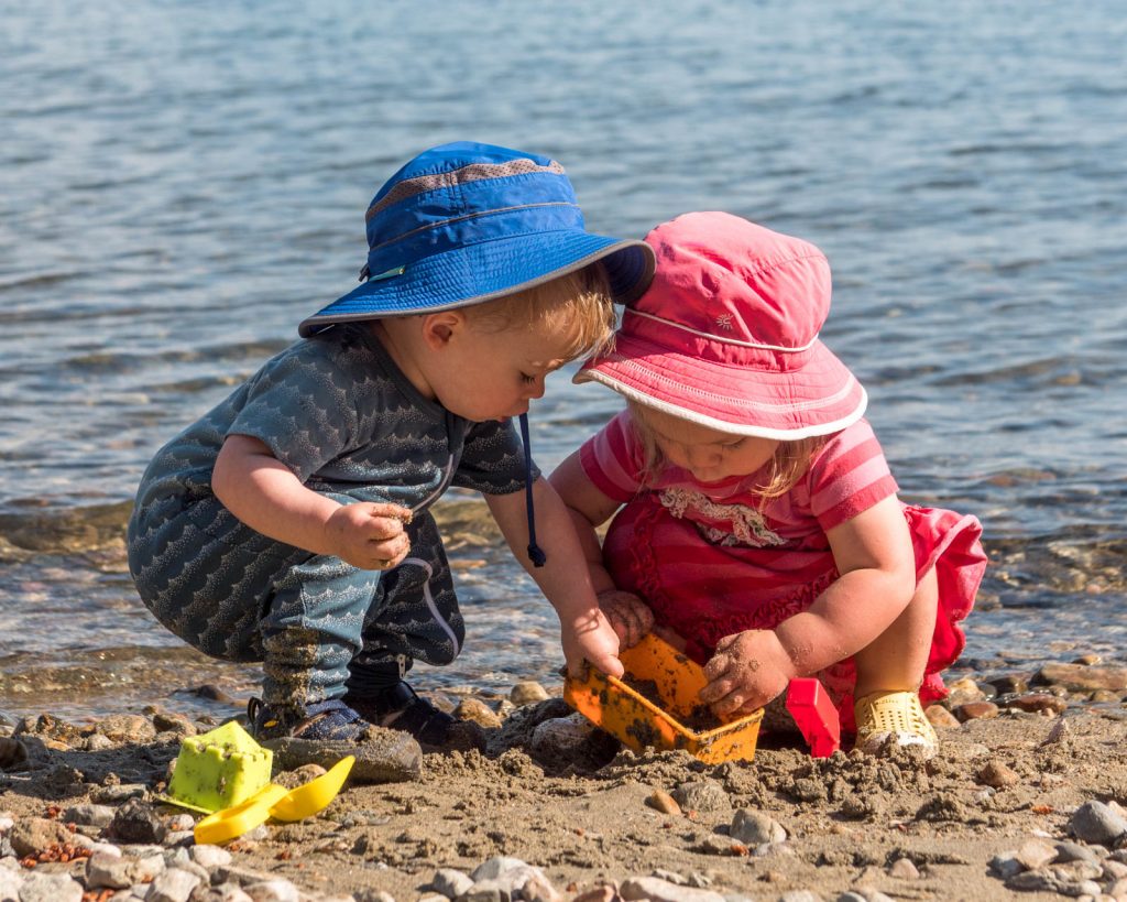 A baby playing with a ball on the beach

Description automatically generated with low confidence