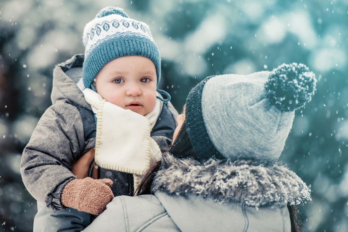 baby playing outside in snow